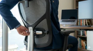 Close-up illustration of a mesh office chair with adjustable lumbar support for back pain relief during long Canadian winters.