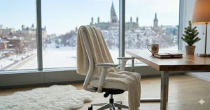 Cozy winter office interior in Ottawa featuring a plush white office chair, a warm throw, and soft lighting.