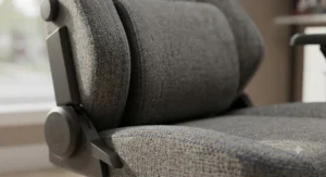 Close-up of a breathable grey fabric gaming chair upholstery featuring premium stitching and texture.